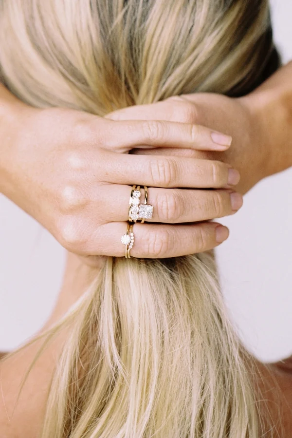Stacked YCL Jewels engagement rings on a hand